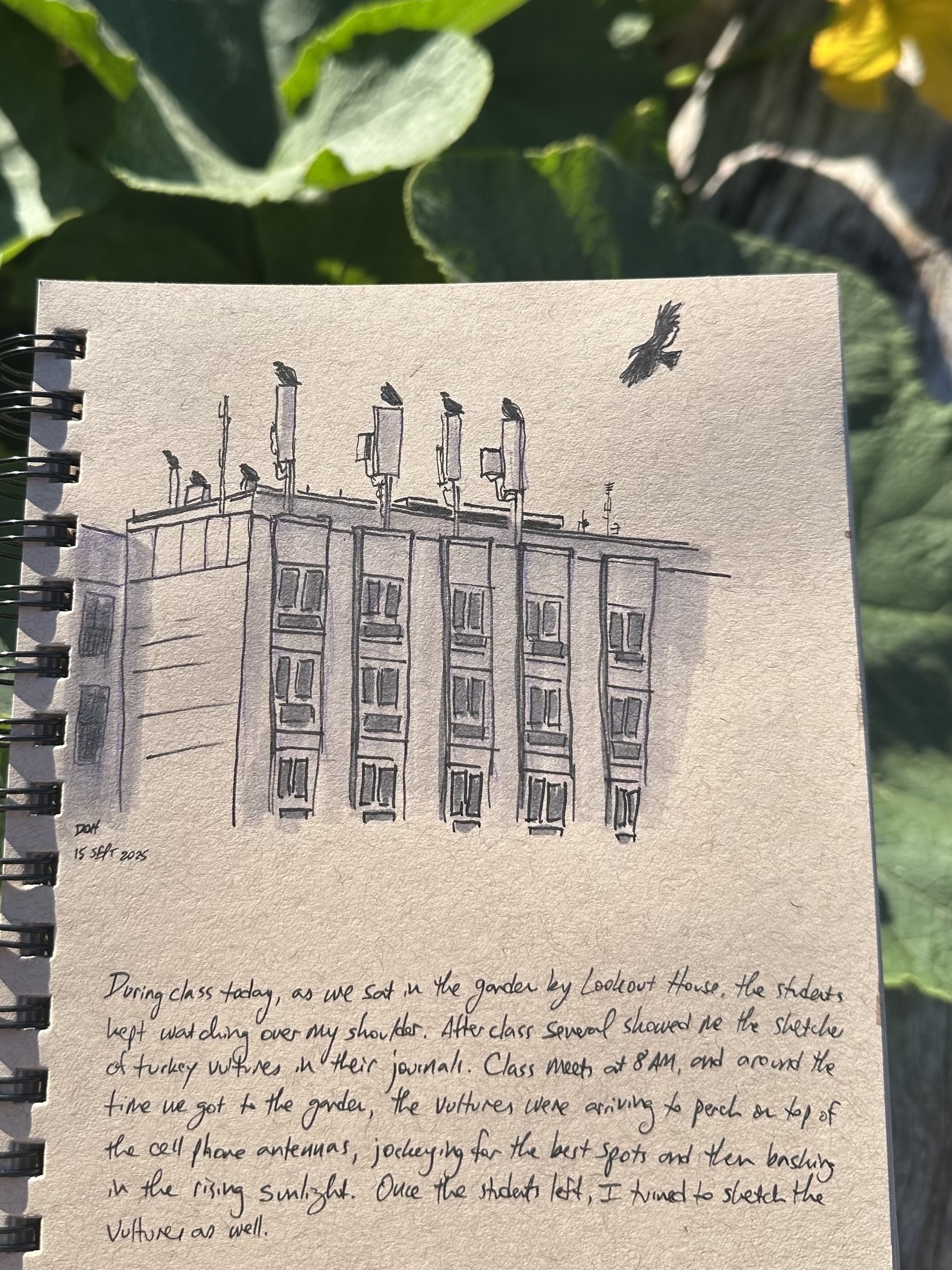 A sketchbook page features a detailed drawing of a building with multiple satellite dishes and a flying bird above it, accompanied by handwritten text.