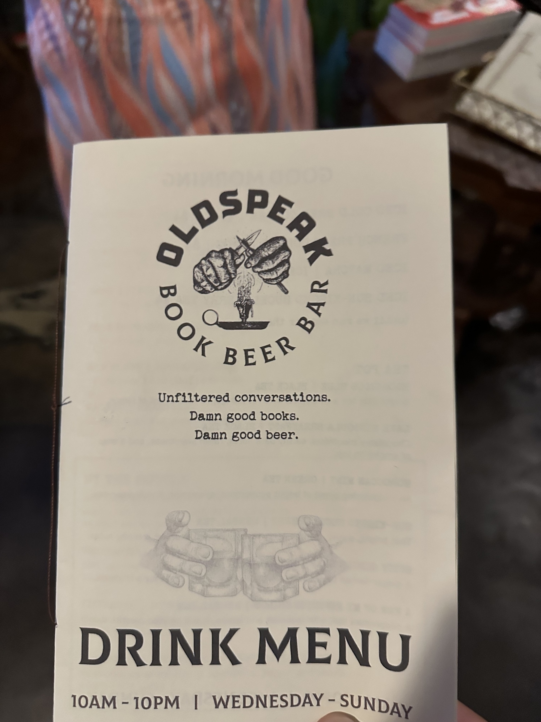 A drink menu from "Oldspeak Book Beer Bar" features the phrases "Unfiltered conversations," "Damn good books," and "Damn good beer."