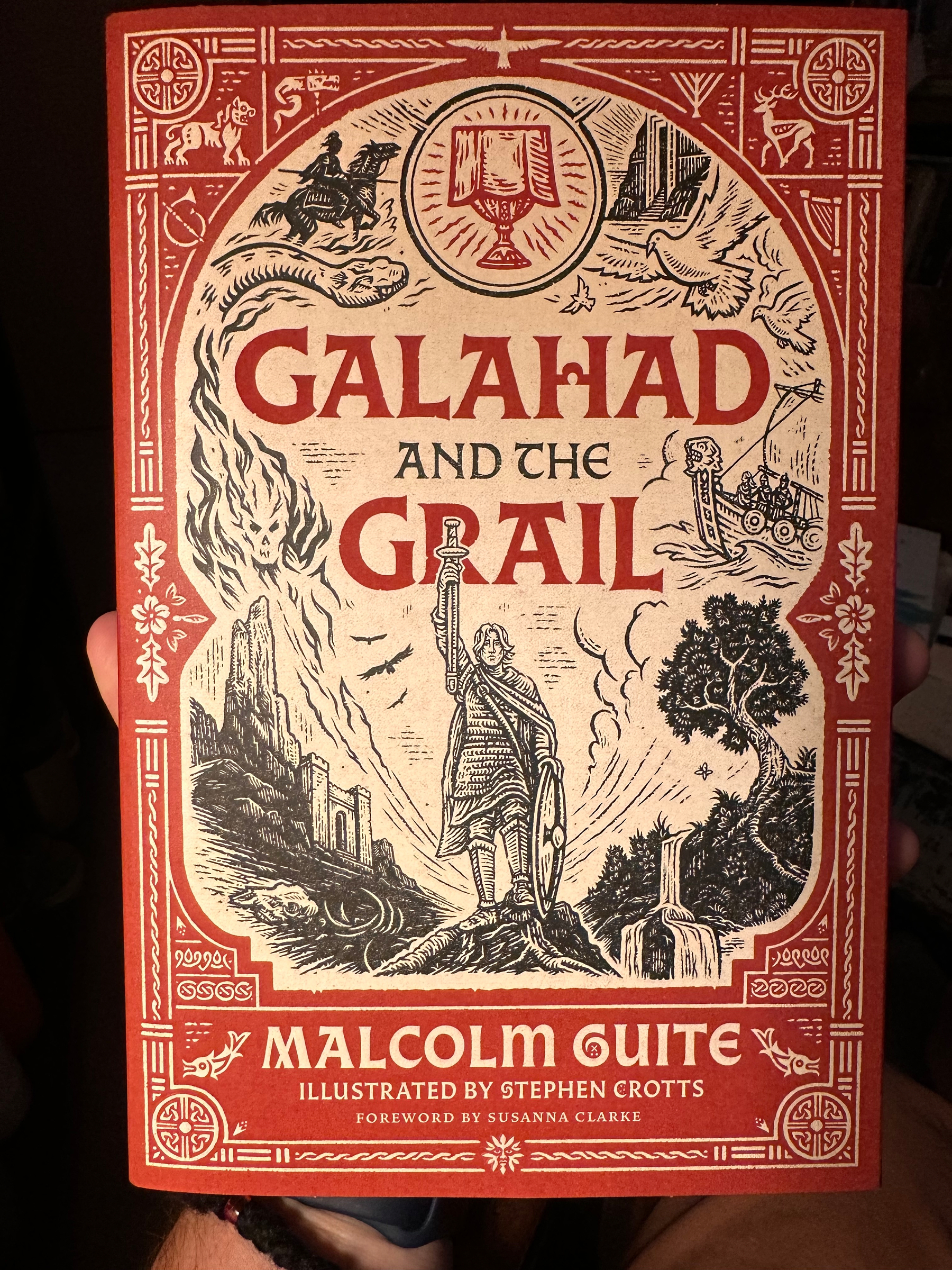 A richly illustrated book cover titled Galahad and the Grail by Malcolm Guite features medieval and mythical imagery including a knight holding a sword, a chalice, a dove, a dragon, and various landscape elements.