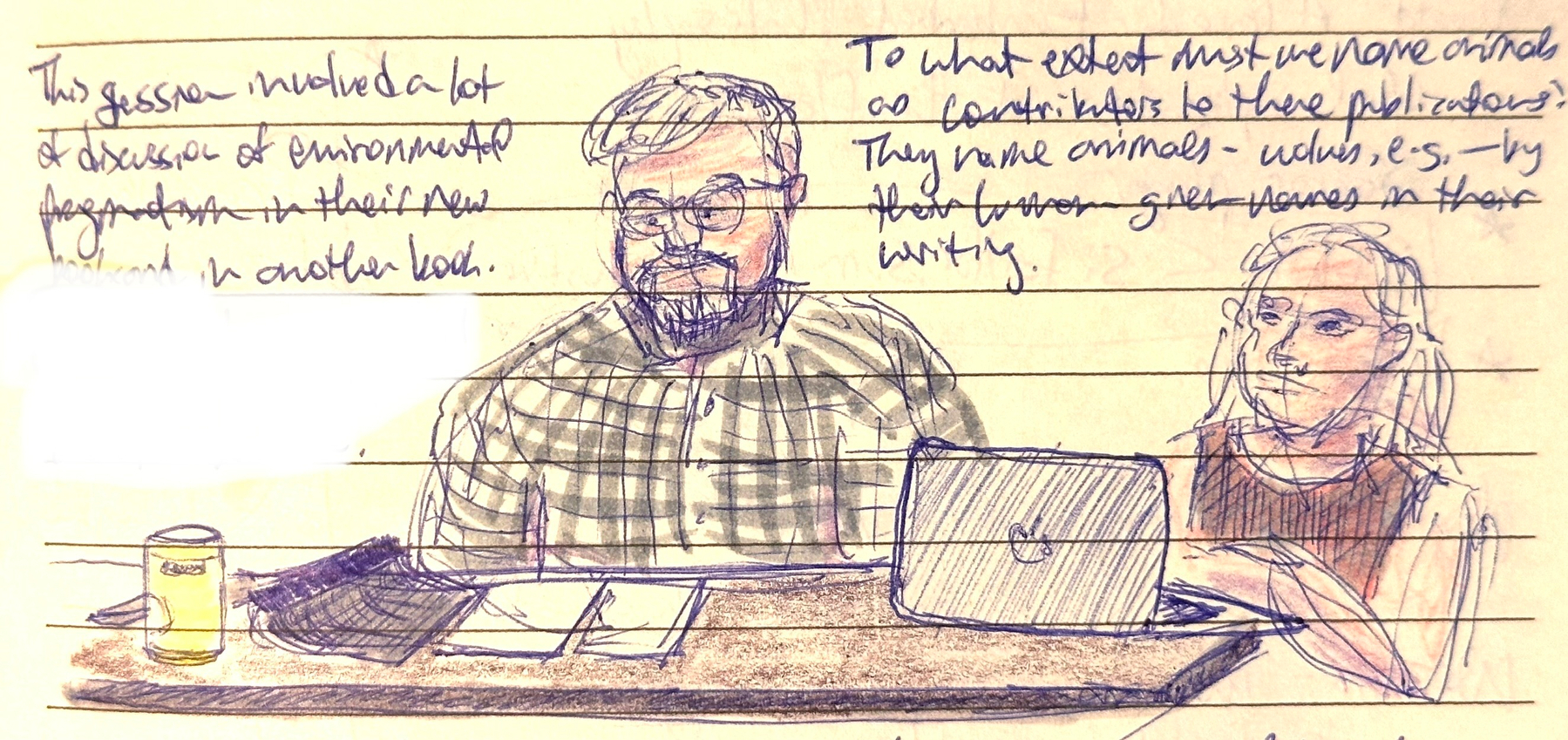 Two people are seated at a table with notebooks, a laptop, and a drink, engaged in discussion with handwritten notes visible above them.